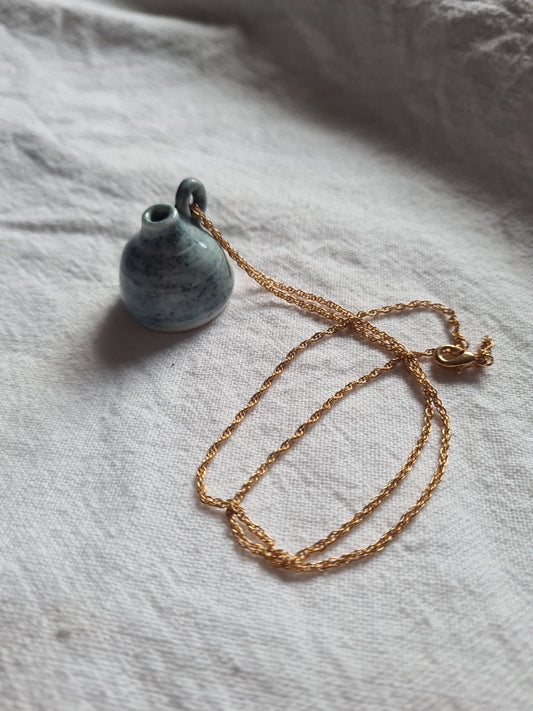 Blue vessel, gold necklace